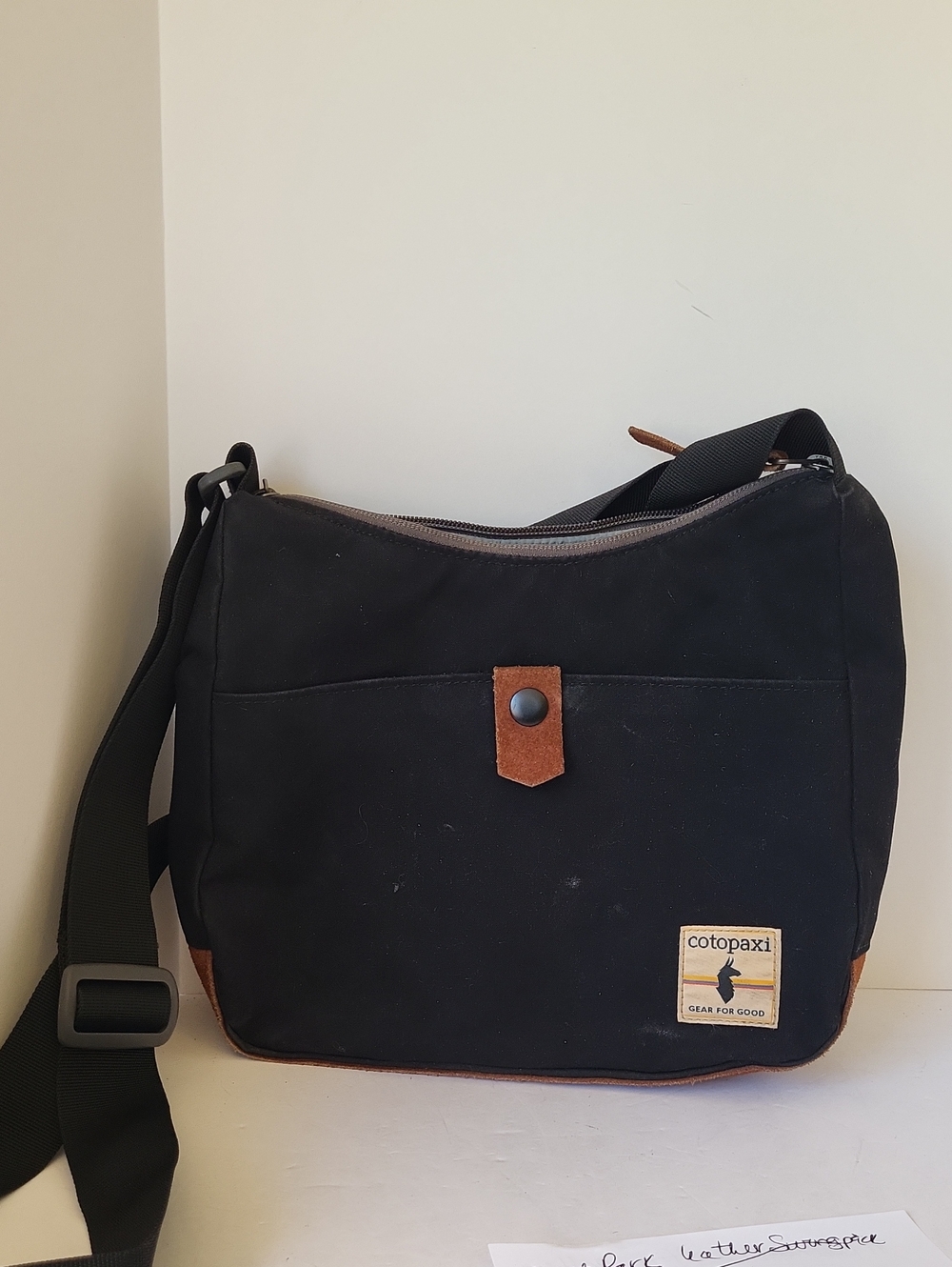 Cotopaxi Perla Black Canvas Crossbody Bag with Brown Leather Accents